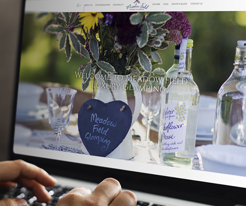Working on a web template on the laptop Meadow Field Website