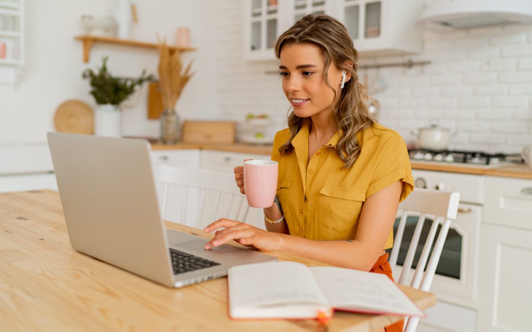 Business owner using laptop in kitchen